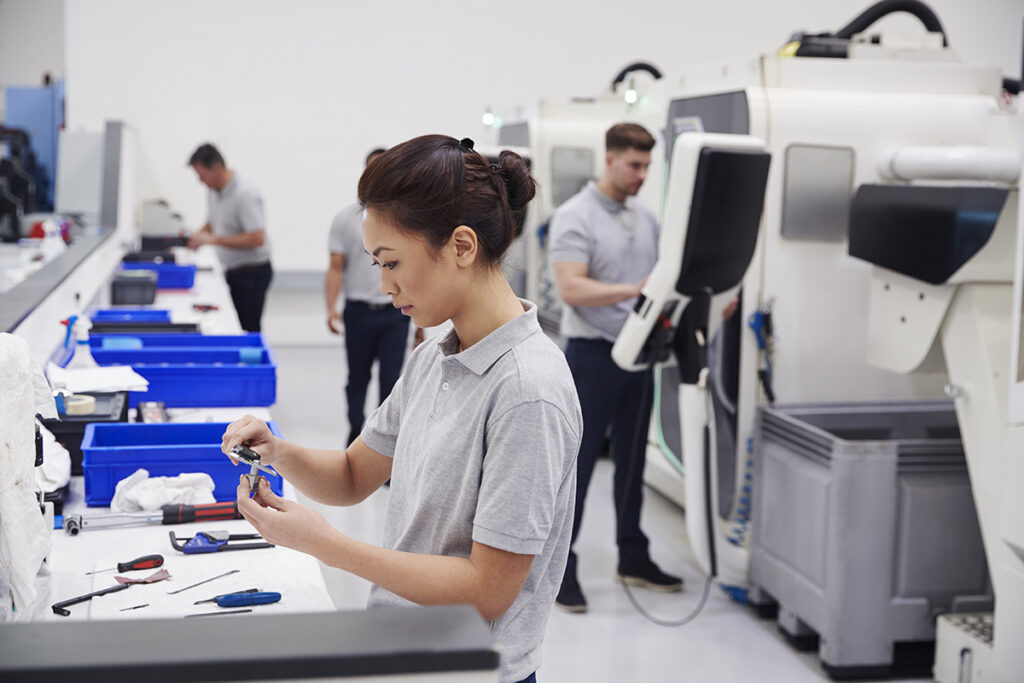 Female Engineer Quality Controlling Components In Factory