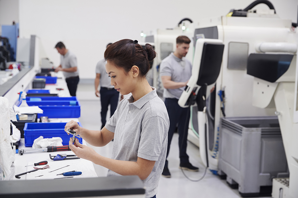 Female Engineer Quality Controlling Components In Factory